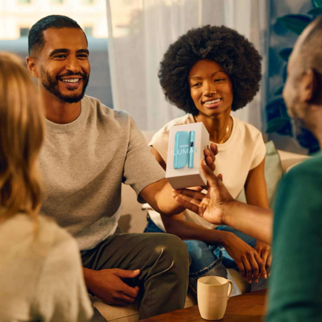 Man and woman unboxing a new IQOS device